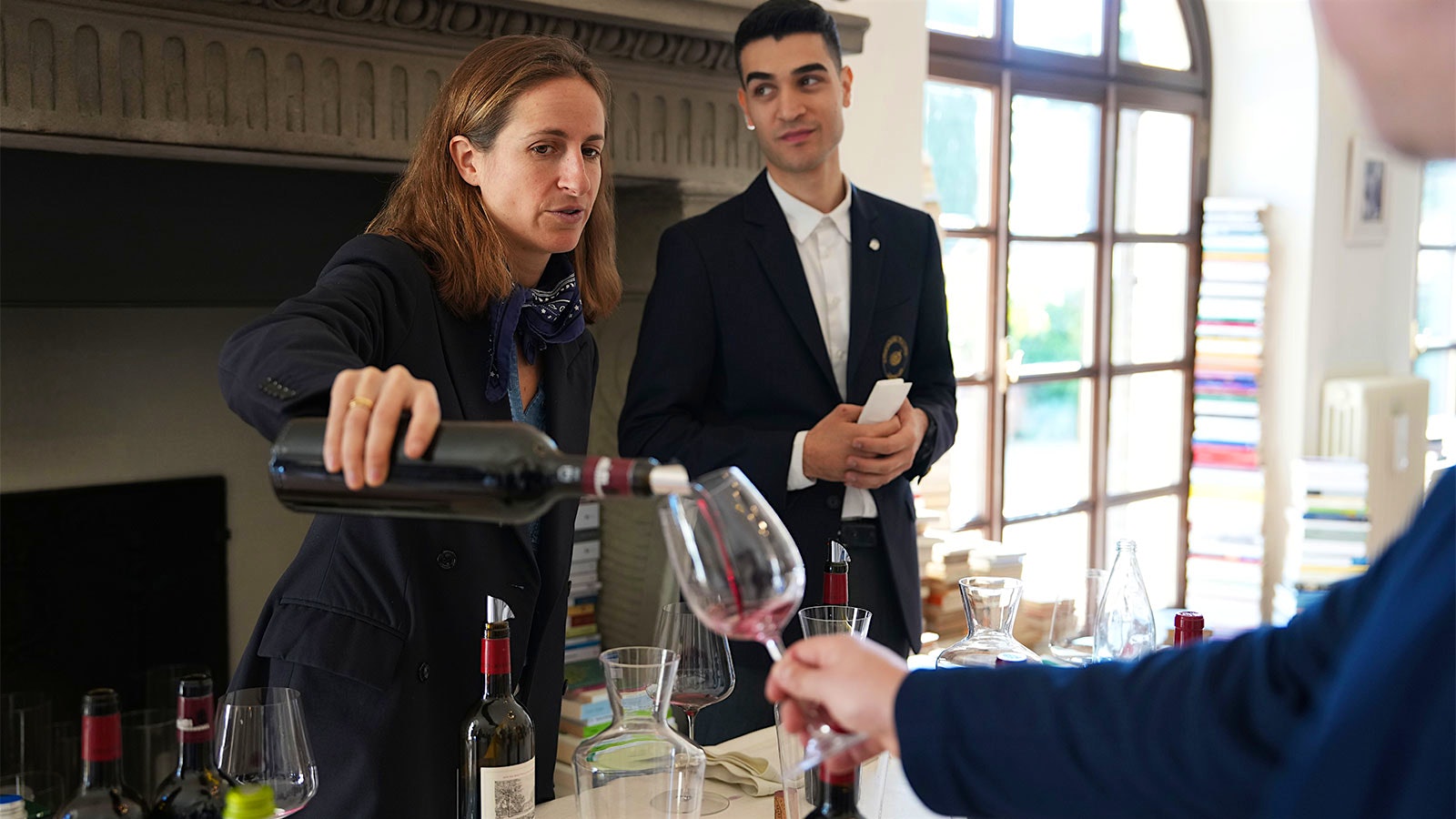 Domaines Baron de Rothschild CEO Saskia de Rothschild pours Château Duhart-Milon Pauillac red at the November 2024 La Paulée event at Castello di Solomeo